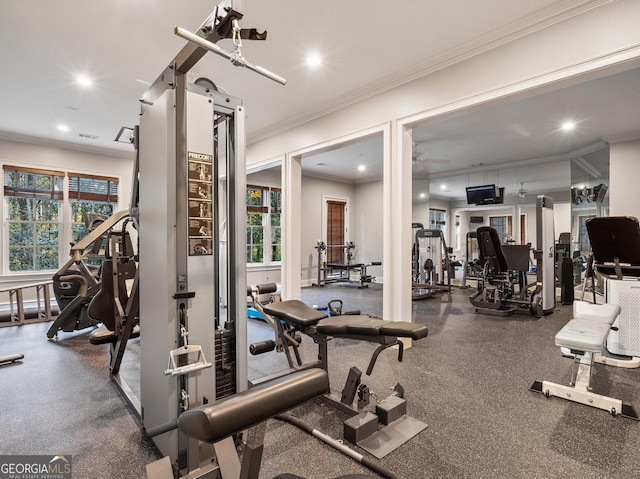 exercise room featuring ceiling fan and ornamental molding