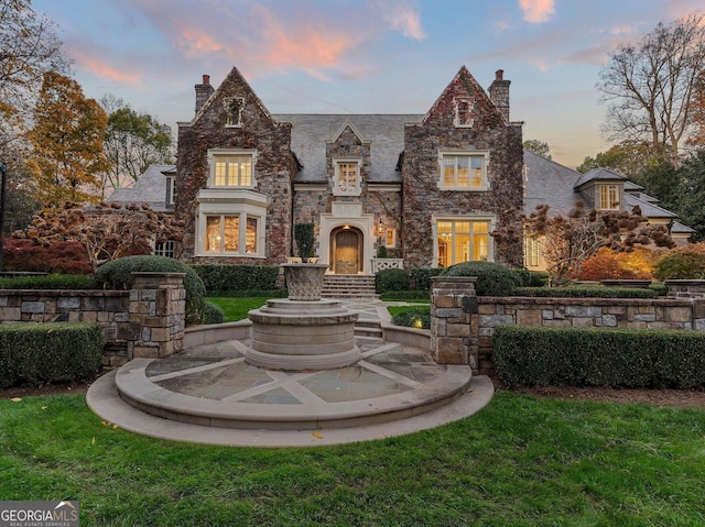 tudor-style house with a lawn