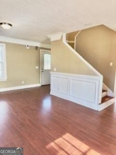 interior space with dark hardwood / wood-style flooring and ornamental molding