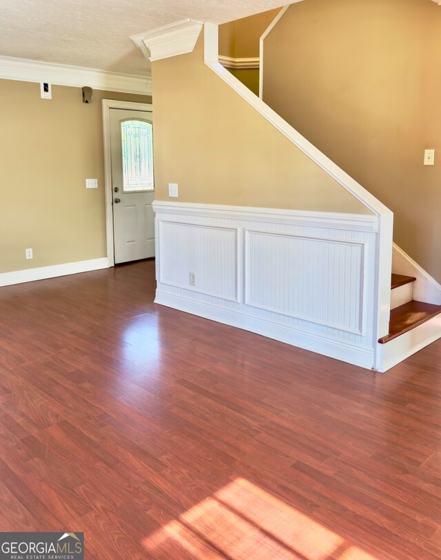 hall with dark hardwood / wood-style flooring and crown molding