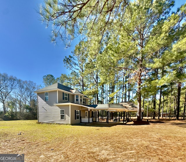 rear view of property with a lawn