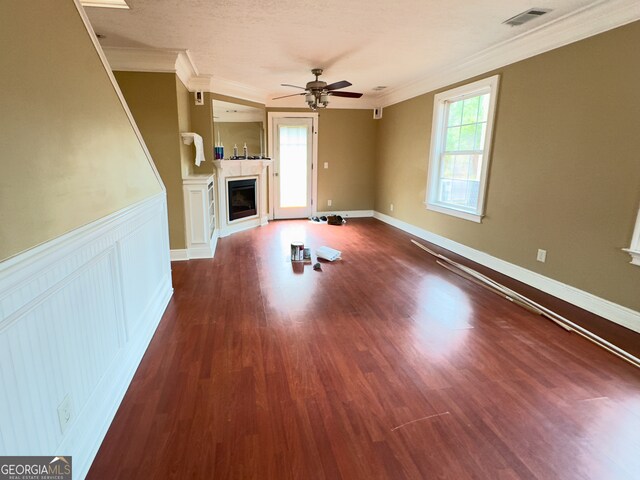 kitchen featuring decorative light fixtures, black fridge, an inviting chandelier, ornamental molding, and white cabinets