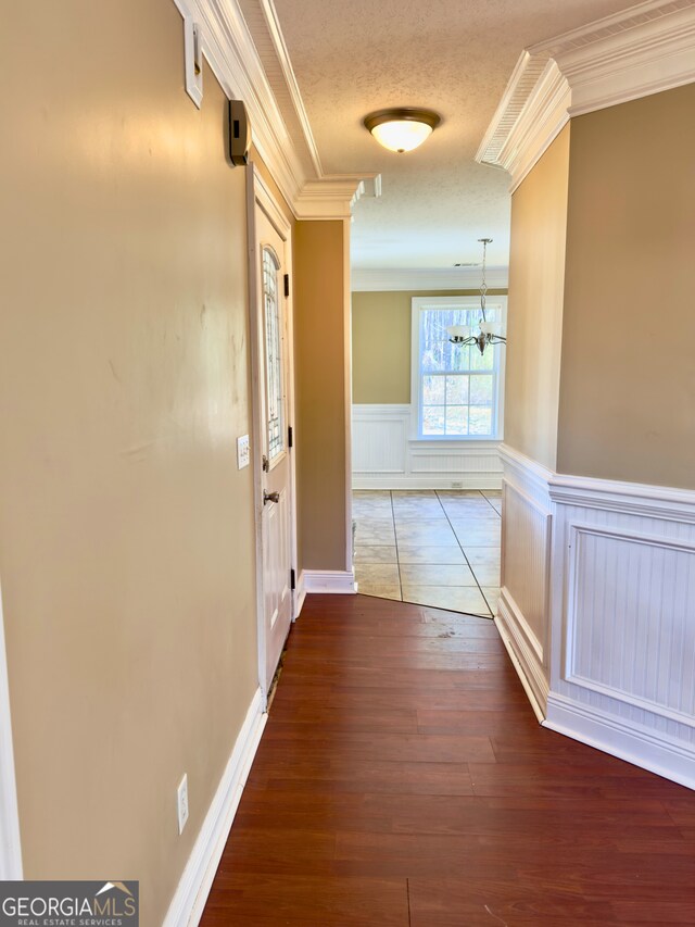 unfurnished dining area with a chandelier and crown molding