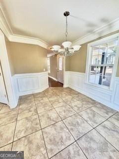 unfurnished dining area featuring a notable chandelier and ornamental molding