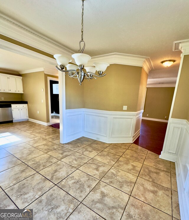 kitchen with stainless steel dishwasher, light tile patterned floors, white cabinetry, and black fridge