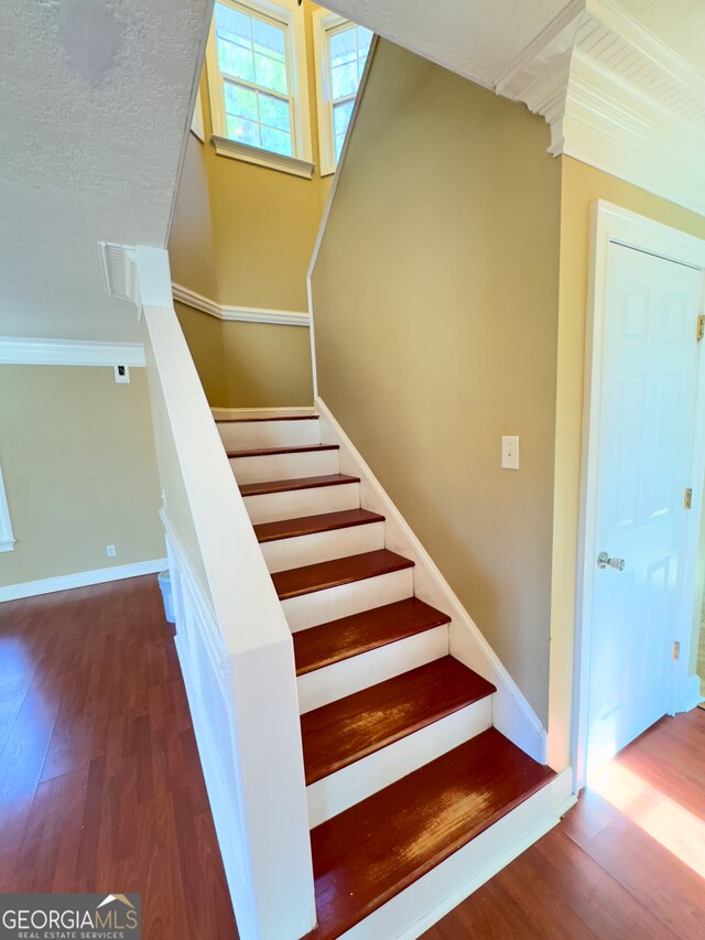 stairway featuring hardwood / wood-style floors