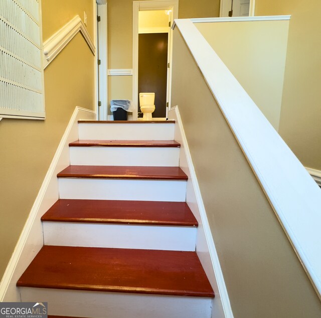 hall with dark hardwood / wood-style flooring and crown molding