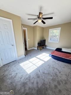 unfurnished bedroom featuring ceiling fan and carpet