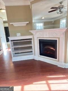 interior details with ceiling fan, a fireplace, and crown molding