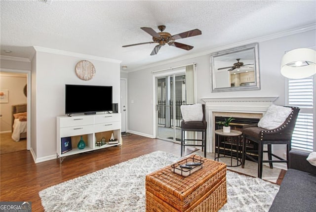 living room featuring a textured ceiling, dark wood-type flooring, and crown molding