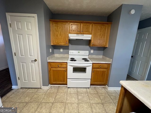 kitchen with white range with electric stovetop and a textured ceiling