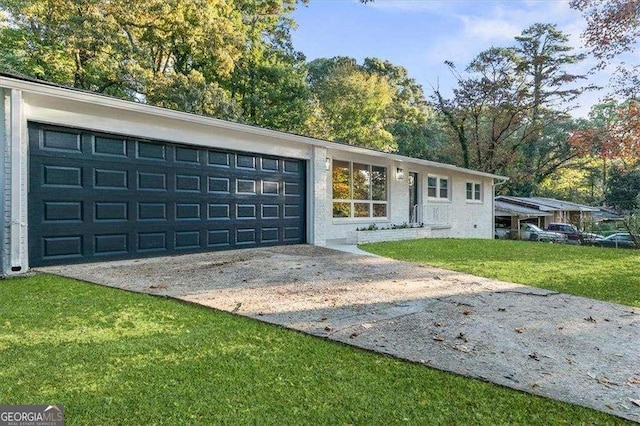 ranch-style home featuring a garage and a front lawn