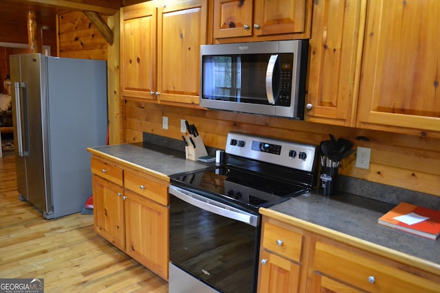 kitchen featuring light wood-type flooring and appliances with stainless steel finishes