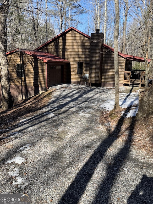 view of snowy exterior featuring a garage