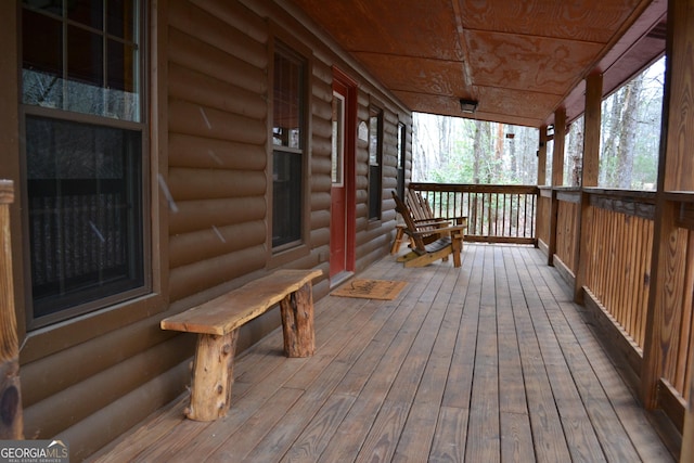 wooden terrace featuring covered porch