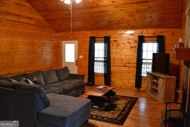 living room with lofted ceiling, wooden ceiling, light hardwood / wood-style floors, and a healthy amount of sunlight