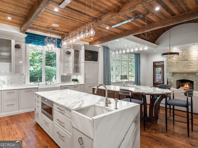 4345 Mount Paran Pkwy NW, Atlanta, GA 30327 - kitchen with wooden ceiling, stainless steel microwave, a sink, wood-type flooring, and glass insert cabinets