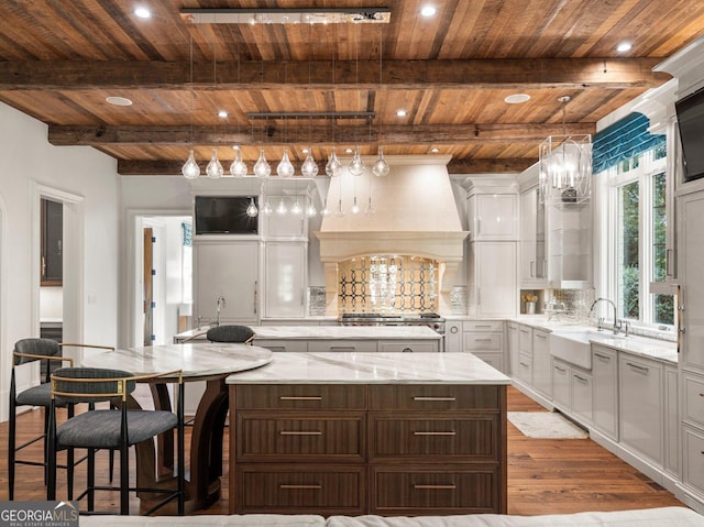 4345 Mount Paran Pkwy NW, Atlanta, GA 30327 - kitchen featuring wood ceiling, a large island, custom range hood, wood finished floors, and white cabinetry