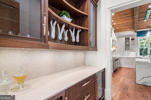 4345 Mount Paran Pkwy NW, Atlanta, GA 30327 - kitchen featuring decorative backsplash, wood-type flooring, beverage cooler, light countertops, and glass insert cabinets