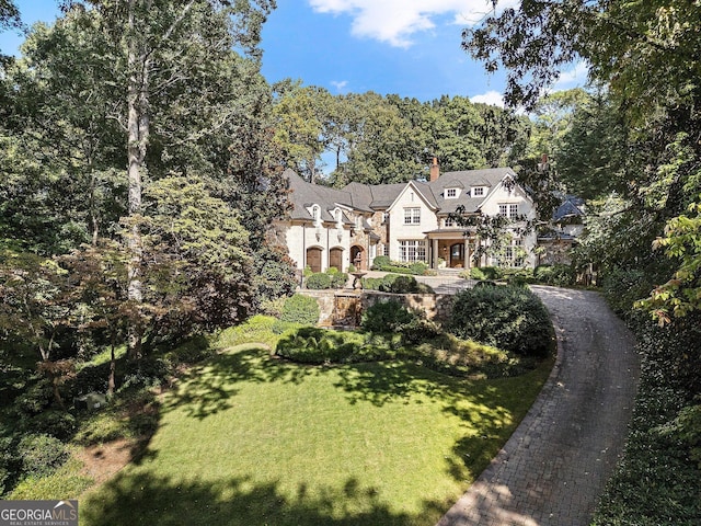 4345 Mount Paran Pkwy NW, Atlanta, GA 30327 - view of front of house featuring a front yard, stone siding, and a chimney