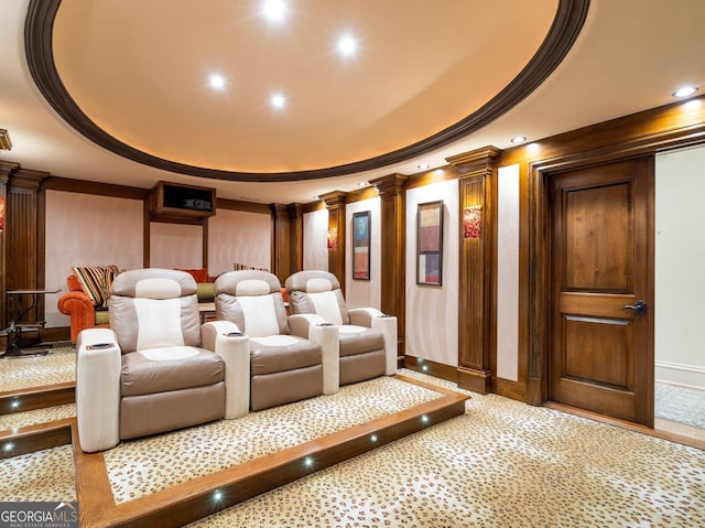 home theater room featuring ornamental molding, a raised ceiling, decorative columns, and recessed lighting