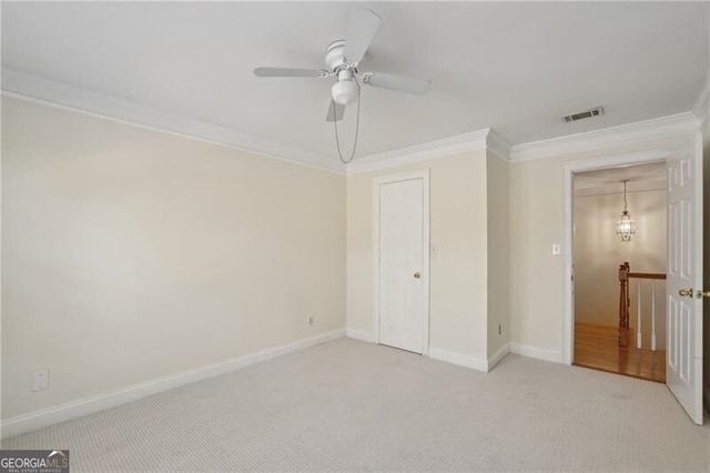 unfurnished bedroom with crown molding, carpet flooring, baseboards, and a ceiling fan