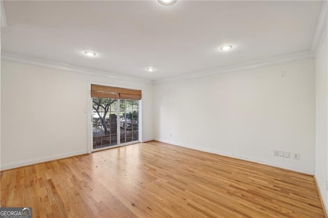 empty room with ornamental molding, light wood finished floors, baseboards, and recessed lighting