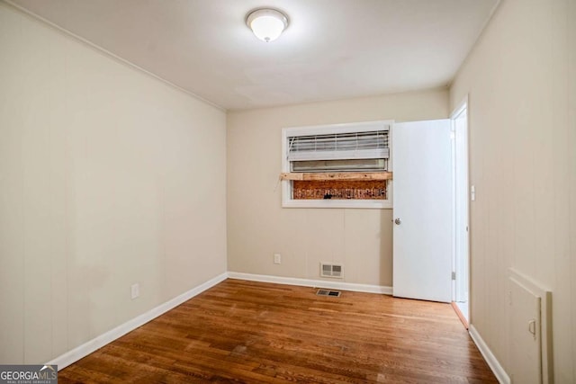 spare room featuring hardwood / wood-style flooring