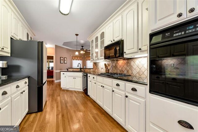 living room with ceiling fan, crown molding, a fireplace, and hardwood / wood-style flooring