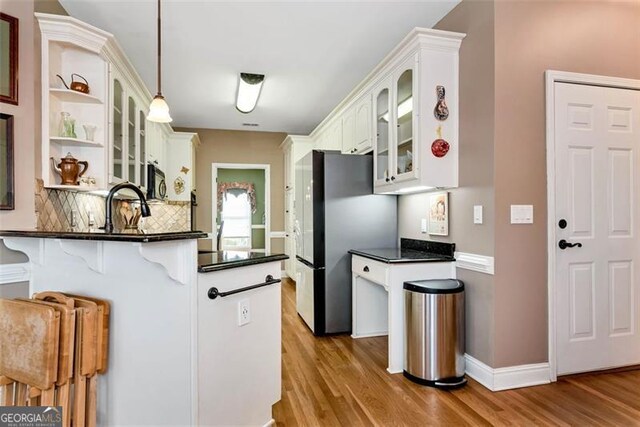 entryway with a wealth of natural light, crown molding, and ornate columns