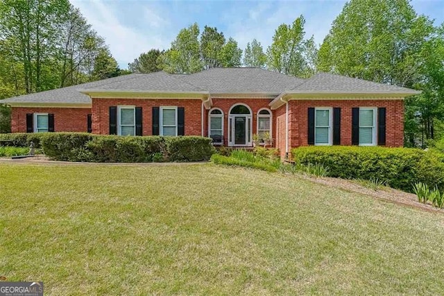 ranch-style home featuring a front yard