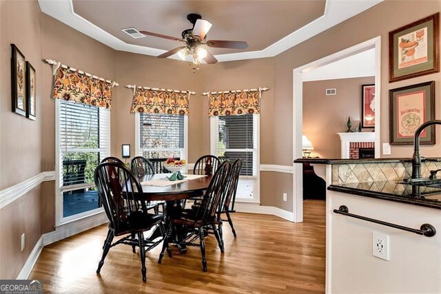 entryway featuring light hardwood / wood-style flooring, ornamental molding, and ornate columns