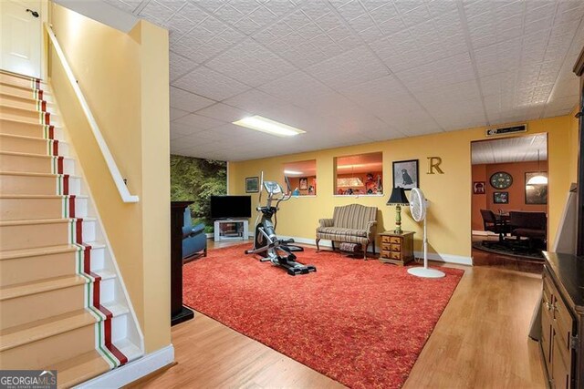 bathroom featuring plus walk in shower, hardwood / wood-style flooring, and vanity