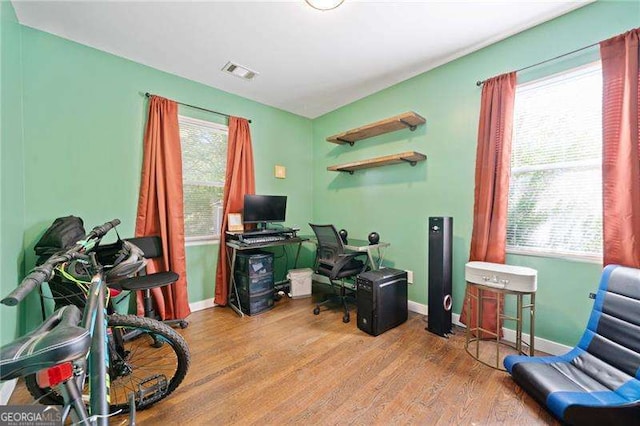 office area with plenty of natural light and light wood-type flooring