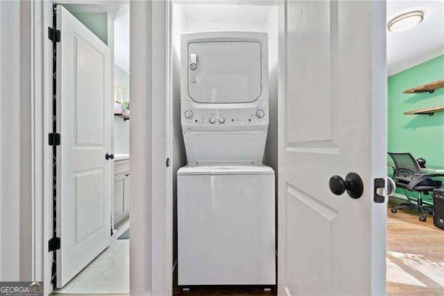 laundry room featuring stacked washer / drying machine