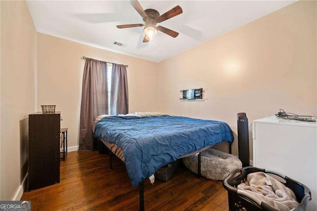 bedroom featuring ceiling fan and dark hardwood / wood-style flooring