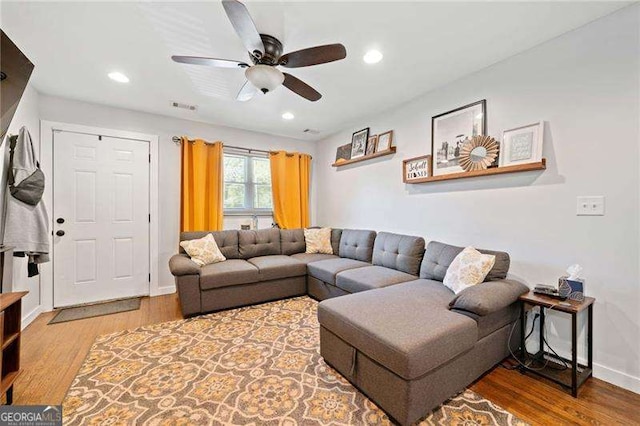 living room with ceiling fan and wood-type flooring