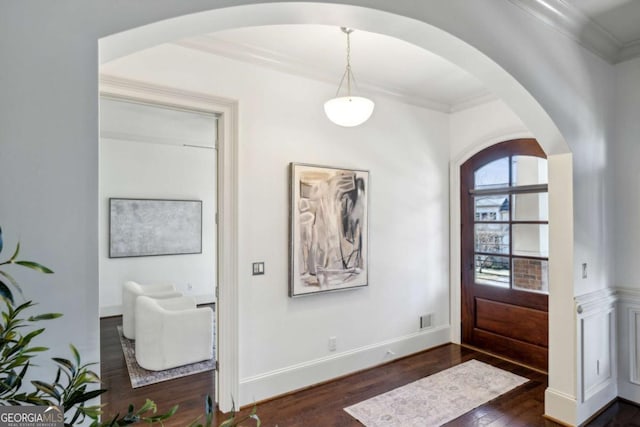 entrance foyer featuring ornamental molding and dark hardwood / wood-style floors