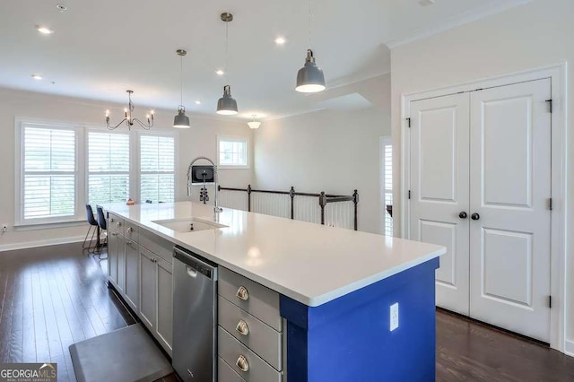 kitchen featuring dishwasher, pendant lighting, sink, a kitchen island with sink, and gray cabinetry