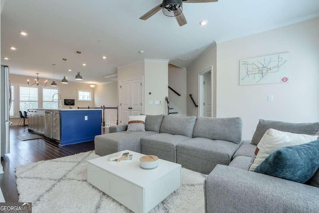 living room featuring ceiling fan, sink, and dark hardwood / wood-style floors