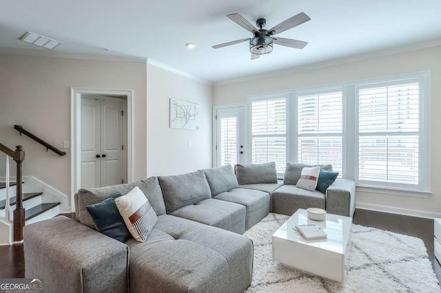 living room featuring ceiling fan, plenty of natural light, wood-type flooring, and ornamental molding