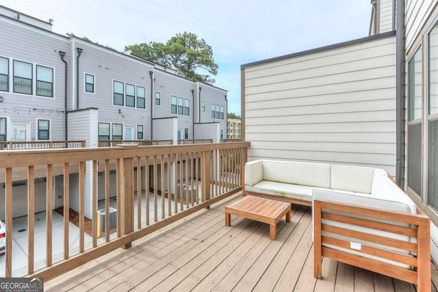 wooden terrace with an outdoor hangout area