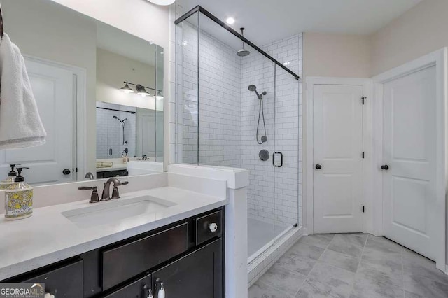 bathroom with walk in shower, vanity, and tile patterned floors