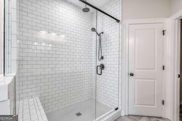 bathroom featuring tile patterned flooring and a shower with door