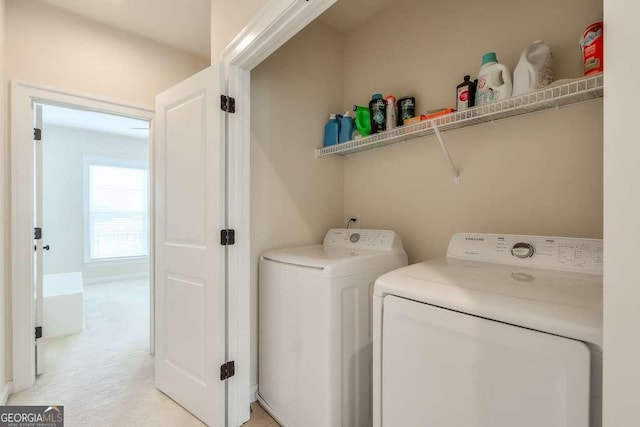 washroom featuring light carpet and washer and dryer