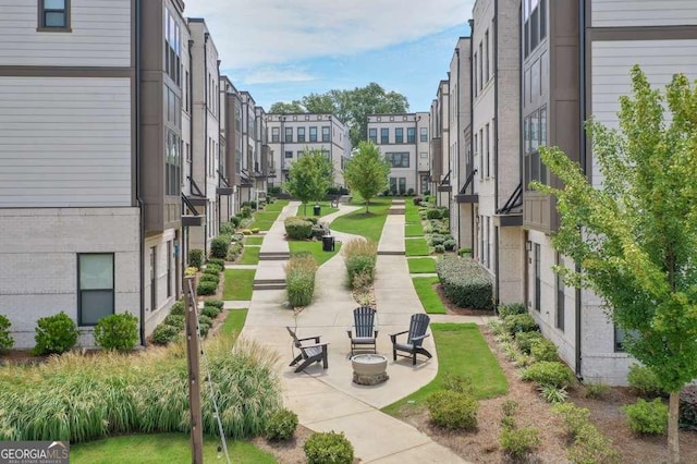 surrounding community featuring an outdoor fire pit