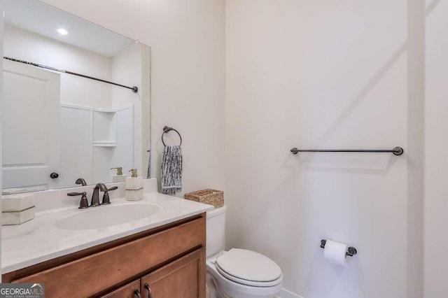 bathroom with toilet and vanity