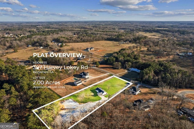 birds eye view of property with a wooded view