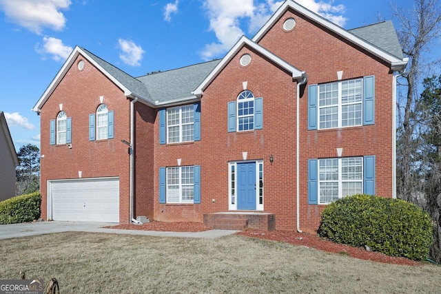 view of front facade with a front yard and a garage