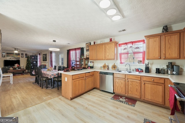 kitchen with pendant lighting, a textured ceiling, sink, kitchen peninsula, and stainless steel dishwasher